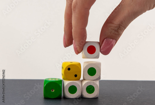 cubes of different colors on the table with hand