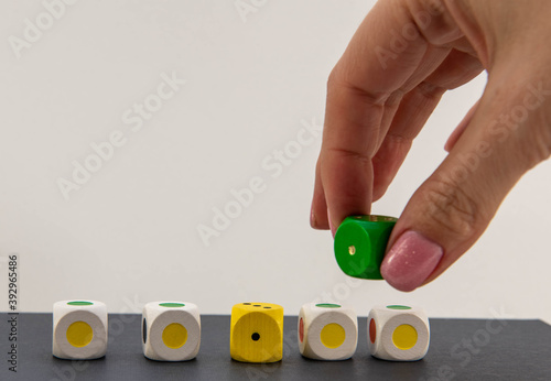 cubes of different colors on the table with hand