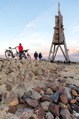 The ‘Kugelbake’, a historic aid to navigation in the city of Cuxhaven, Germany, at the northernmost point of Lower Saxony, where the River Elbe flows into the North Sea at sunset.