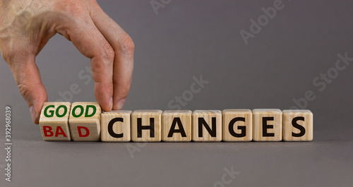 Male hand turns cubes and changes the expression 'bad changes' to 'good changes'. Beautiful grey background. Copy space.