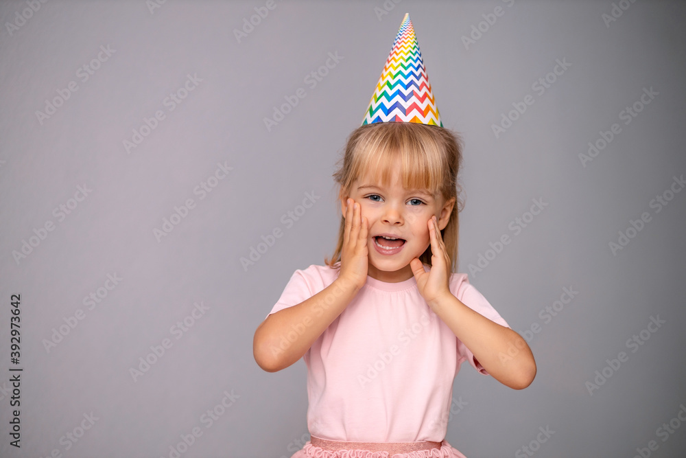 Young beautiful girl in birthday cap over isolated background smiling with happy face Young beautiful girl in birthday cap over isolated background smiling with happy face