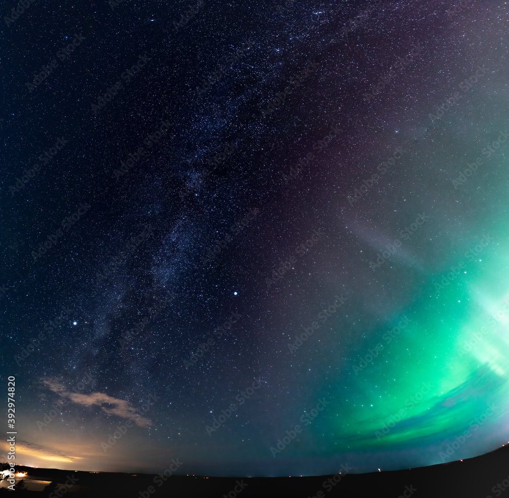 Obraz premium Amazing panorama of scenic vertical Milky Way stars and galaxies and Aurora Borealis glow under starry sky above horizon line, photo taken at late night