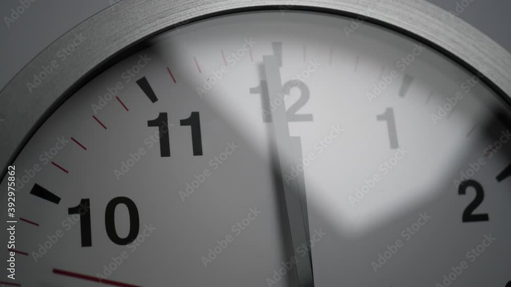 Close up of a white ticking clock on white background, pointing midnight, window reflection, time lapse Close up of a white ticking clock on white background, pointing midnight, window reflection, time lapse
