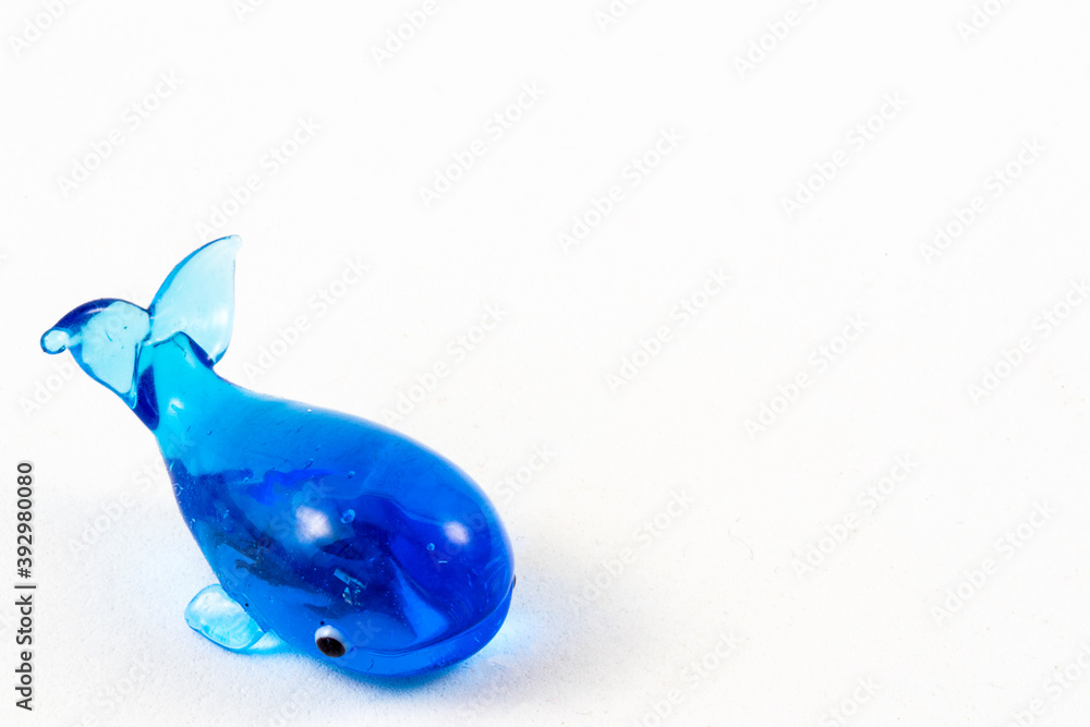 Close up of tiny blue glass whale Close up of tiny blue glass whale