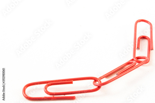 Close up of three linked pink paperclips