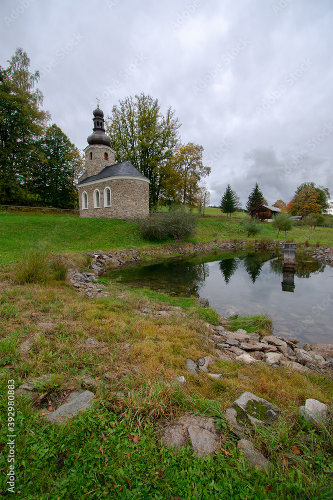 Obraz premium Chapel and lake at Vatetice, Sumava national park, Czech republic