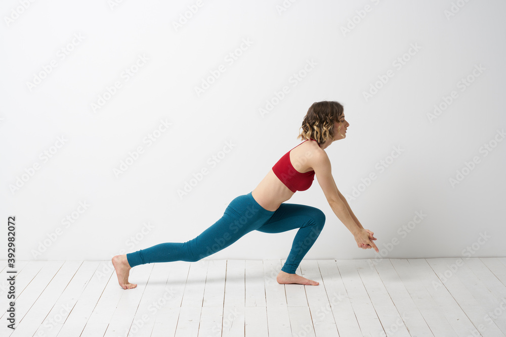 woman in leggings is engaged in gymnastics in a light room slim figure fitness sport woman in leggings is engaged in gymnastics in a light room slim figure fitness sport