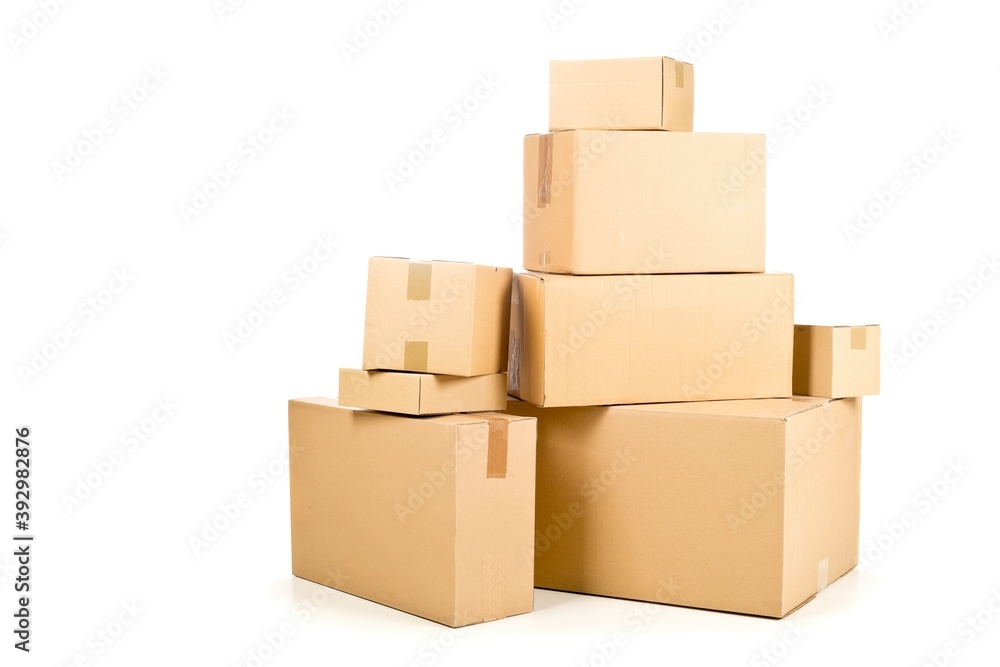 Stack or heap of brown carton cardboard boxes over white, freight, deilvery or shipping concept