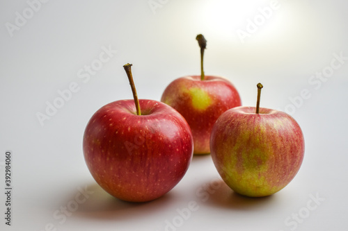 Close-up of three red apples on a white background. Fruit. Harvest.