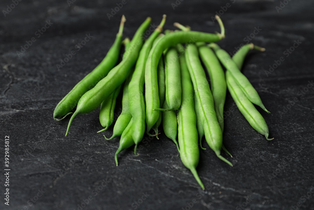 Fresh green beans on black table, closeup Fresh green beans on black table, closeup