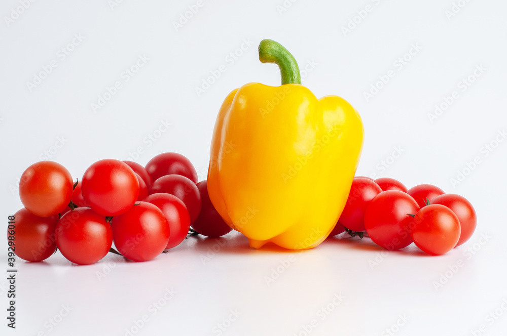 Photo of a yellow pepper and two tomatoes twig Photo of a yellow pepper and two tomatoes twig