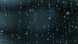 MACRO: Clear raindrops accumulate on the windowpane during a severe rainstorm.