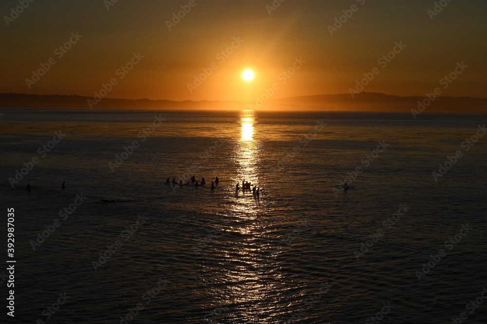 Fototapeta premium surfers at sunrise