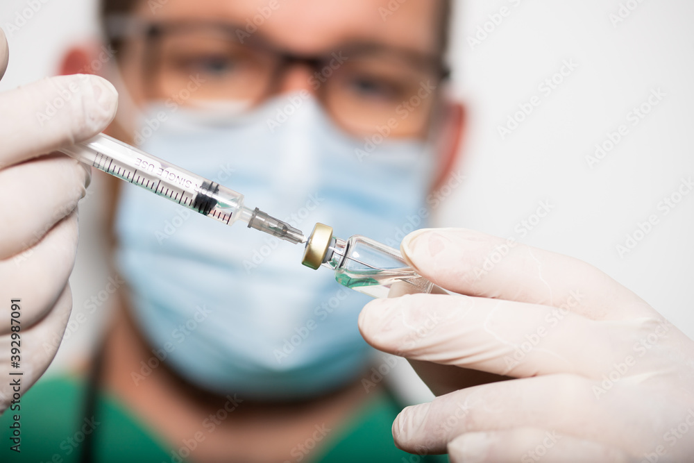 doctor holding covid - 19 coronavirus vaccine doctor holding covid - 19 coronavirus vaccine