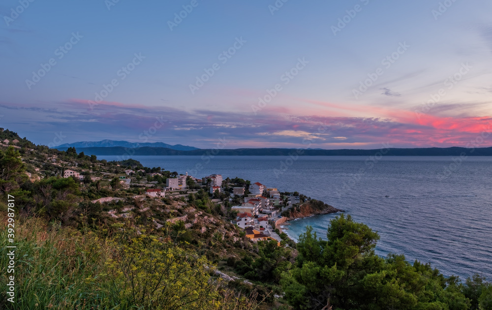 Drasnice is a tourist locality or village in southern Dalmatia, Croatia, located between Makarska and Podgora and underneath the Biokovo mountains. Top view at sunset. September 2020