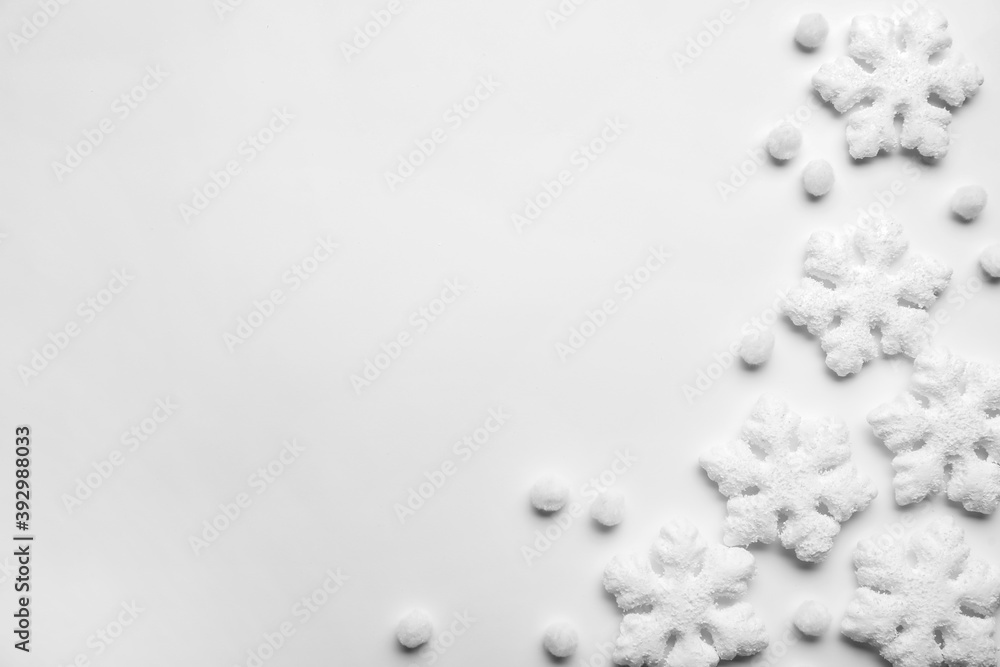 Beautiful snowflakes and decorative balls on white background, flat lay. Space for text Beautiful snowflakes and decorative balls on white background, flat lay. Space for text