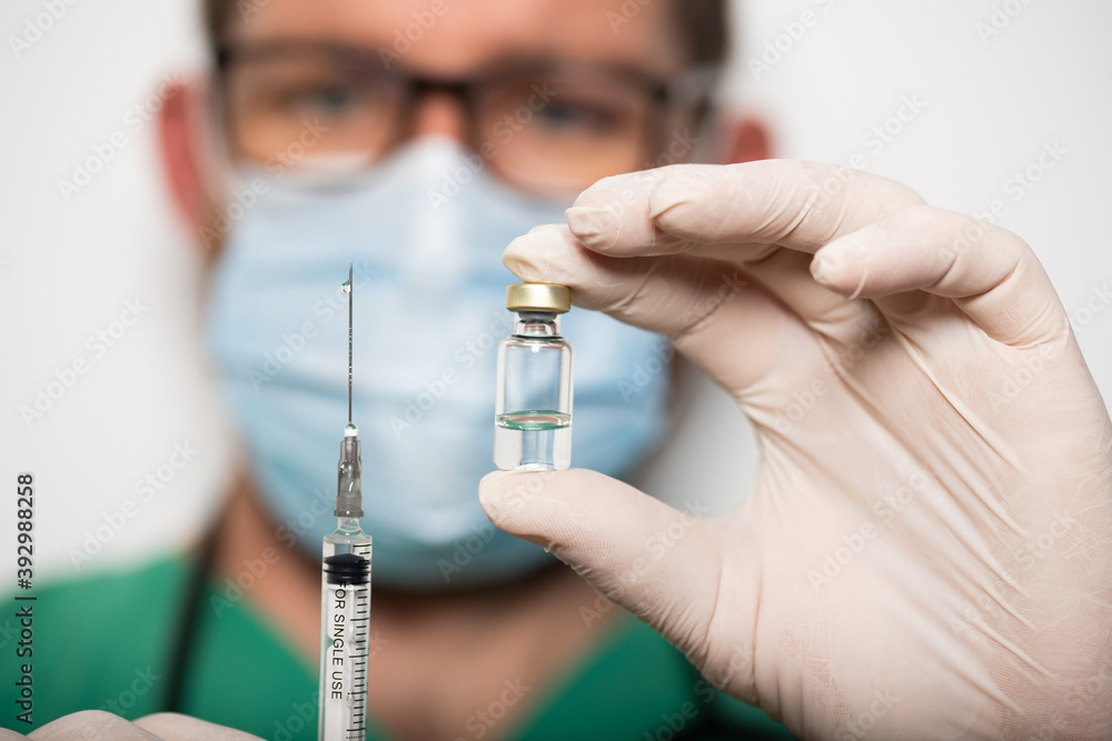 doctor holding covid - 19 coronavirus vaccine doctor holding covid - 19 coronavirus vaccine