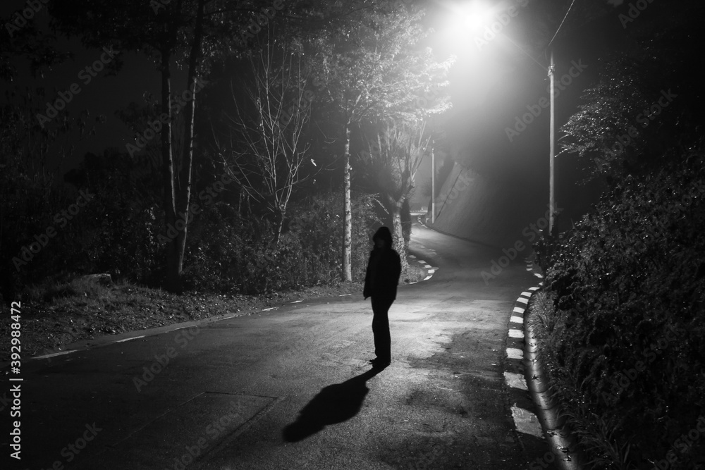 Photograph of an apparition on an empty road at night