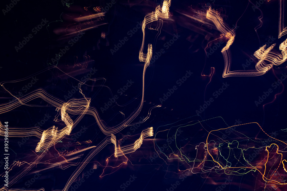 Colorful light patterns swirling in the night (long exposure photo of car and road lights shoot from moving vehicle). Colorful light patterns swirling in the night (long exposure photo of car and road lights shoot from moving vehicle).