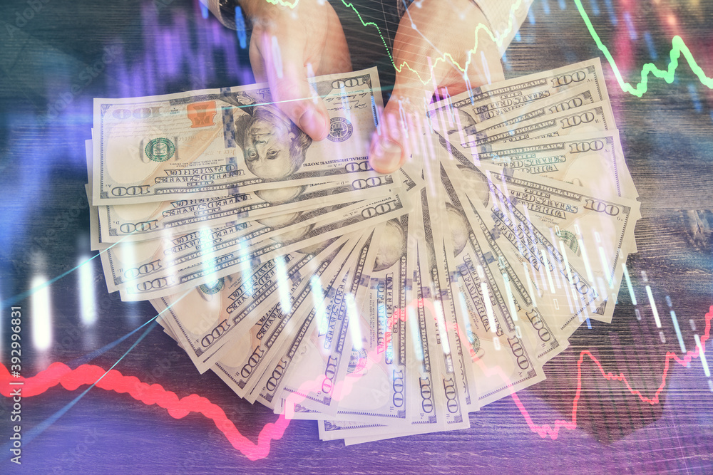 Multi exposure of financial graph drawing hologram and USA dollars bills and man hands. Analysis concept. Multi exposure of financial graph drawing hologram and USA dollars bills and man hands. Analysis concept.