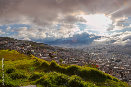 Sun shines through the clouds in Quito city in Ecuador 