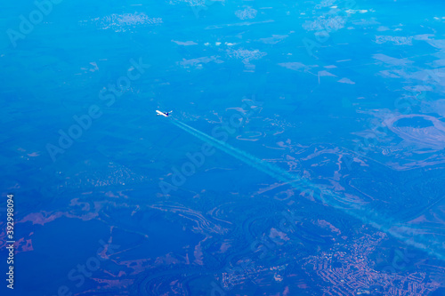Aerial view of airplane flying over the earth 