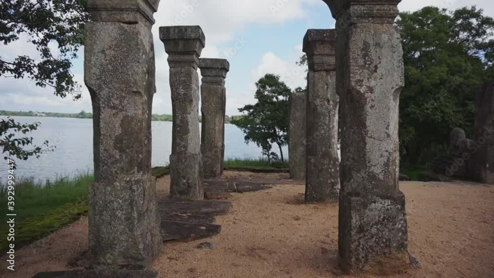 Tall stone pillars in a temple ground, near a lake Tall stone pillars in a temple ground, near a lake