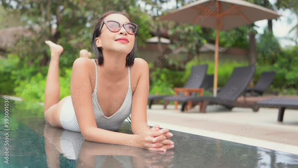 Lying on her stomach and kicking her feet slowly in the air, an