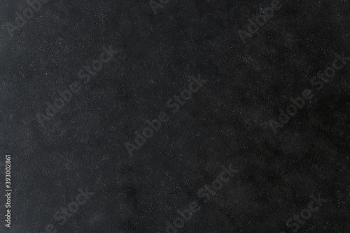 Old black and grey texture background made of stone and concrete. Concept of food and product photography.
