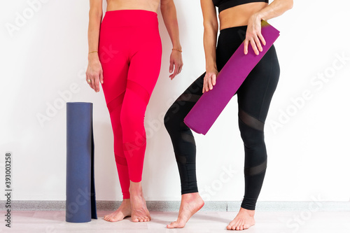Women holding yoga mats, close-up