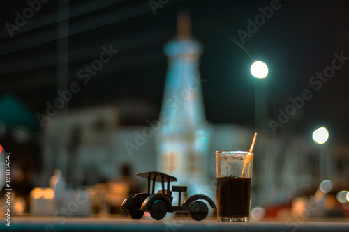 Kopi jos yogyakarta, jos coffee is a typical angkringan drink from yogyakarta with a mixture of charcoal. object coffee with the background of the Jogja monument photo