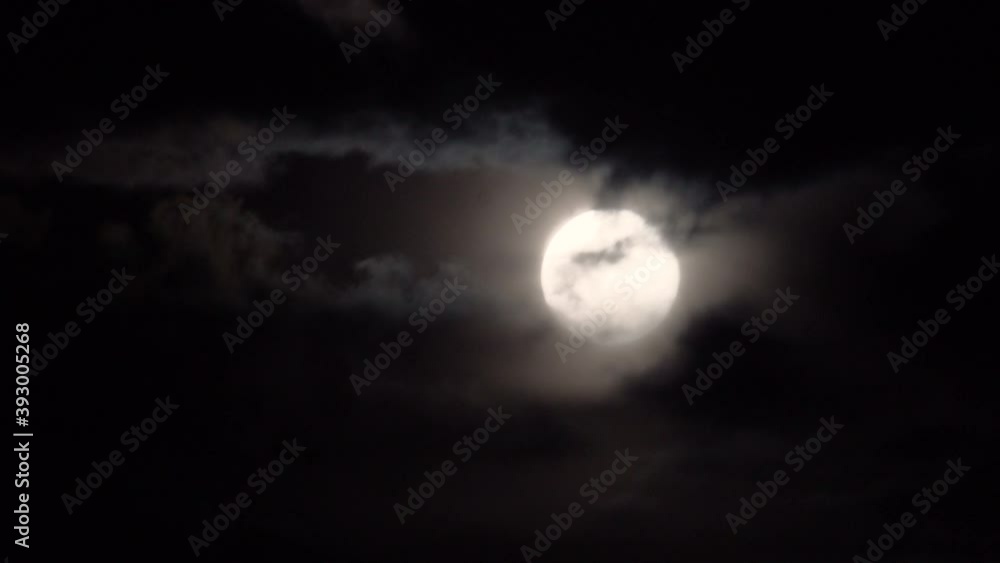 Full moon with spooky clouds passing in front on a dark night. Full moon with spooky clouds passing in front on a dark night.