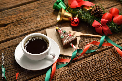 Cup of coffee with Christmas decorations on old wooden table