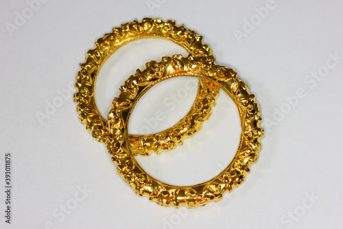 Beautiful Indian style gold bangles/jewelry laying on white background 