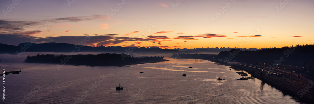 Aerial Panoramic View of Fraser River. Dramatic Colorful Sunrise Sky. Taken over Port Mann Bridge in Surrey, Vancouver, British Columbia, Canada.