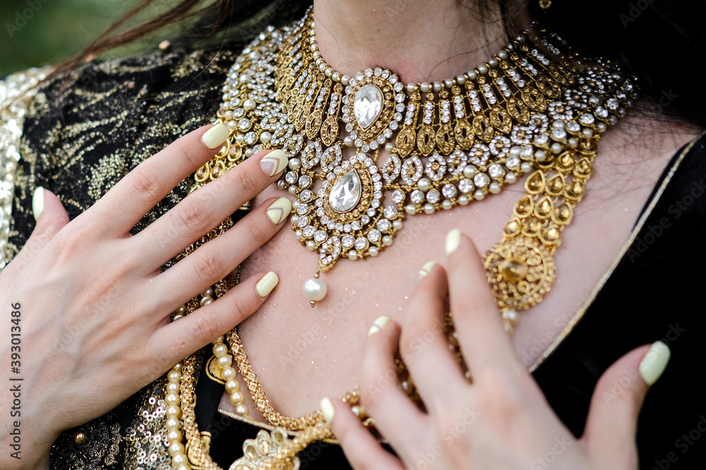 Portrait of a female model in ethnic indian costume with jewellery and traditional makeup.