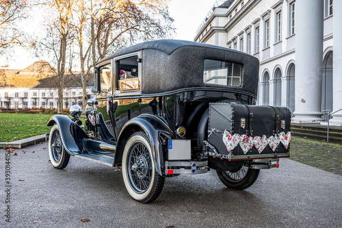 Wedding Couple in old antique Oldtimer Car 1928 during a Wedding Decorated