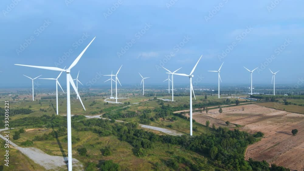 Many wind turbines for generating electricity on the grasslands with mountains and sky as a background in Thailand. Many wind turbines for generating electricity on the grasslands with mountains and sky as a background in Thailand.