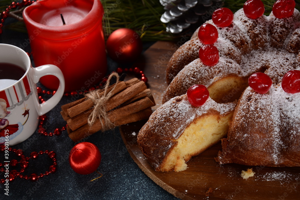 Christmas and New Year concept. Delicious lemon cake with red sweet cherries and sugar powder.