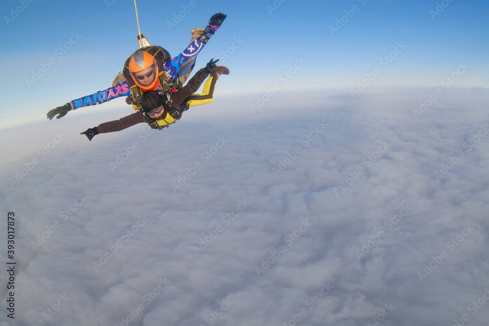 Skydiving. Tandem jump. The flight is above clouds.