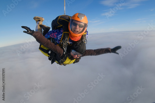 Skydiving. Tandem jump. The flight is above clouds.