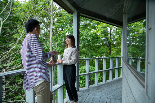 Man and Woman Laughing on the Terrace of Cafe