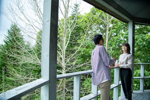 Man and Woman Laughing on the Terrace of Cafe