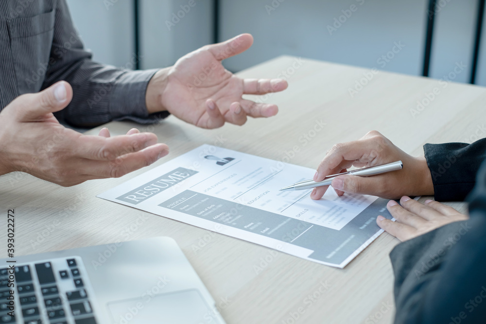 Business people hold a resume and talk to job applicants for job interviews about careers and Her personal history in the company. Recruitment concepts Business people hold a resume and talk to job applicants for job interviews about careers and Her personal history in the company. Recruitment concepts