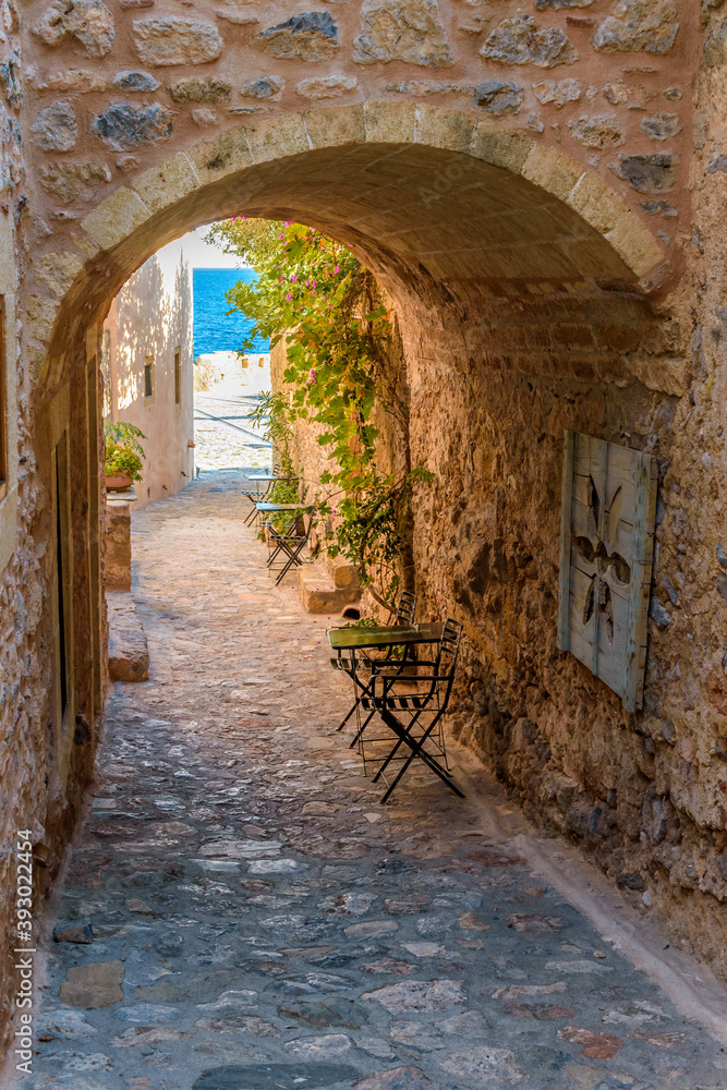 Obraz premium View of traditional architecture and yellow stone's arch from the medieval castle of Monemvasia, Lakonia, Peloponnese.