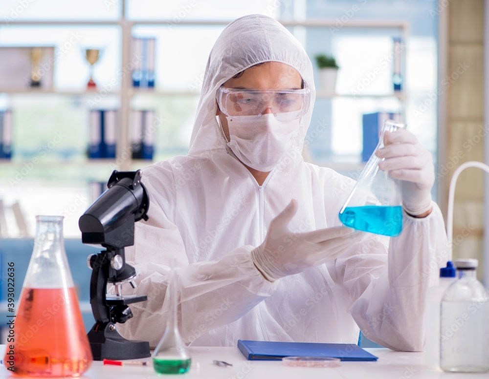 Chemist working in the laboratory with hazardous chemicals Chemist working in the laboratory with hazardous chemicals