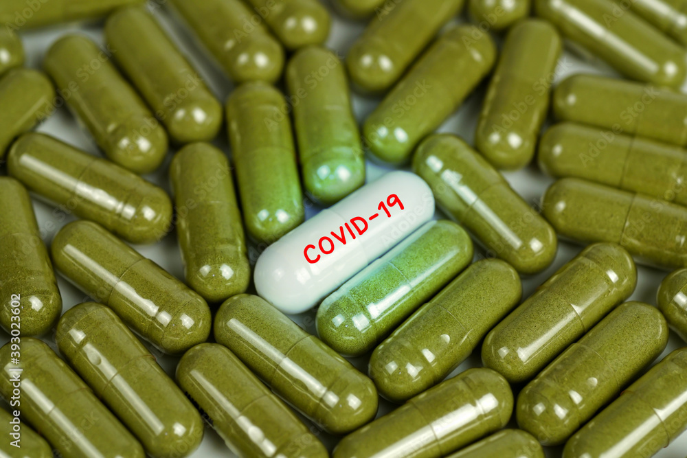 view a white pill word - COVID-19 with many green pills, close up. Medical concept of Virus Pandemic Protection, Coronavirus COVID-19.Selective focus.
view a white pill word - COVID-19 with many green pills, close up. Medical concept of Virus Pandemic Protection, Coronavirus COVID-19.Selective focus.