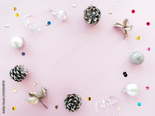 Silver Christmas decorations on a pink background, pattern, ornament. Gentle new year's concept, flat lay, top view, copy space. Christmas monochrome composition