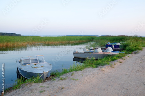 Boats at the pier in the Bay of lake Seliger at sunset