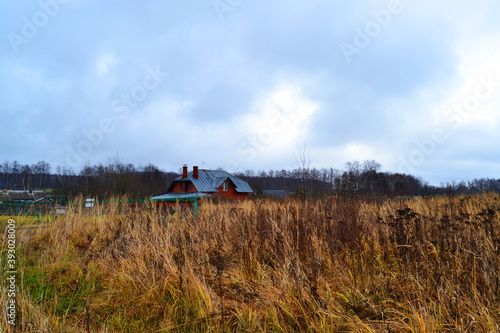 Fototapeta Naklejka Na Ścianę i Meble -  Wooden old house in the field in autumn